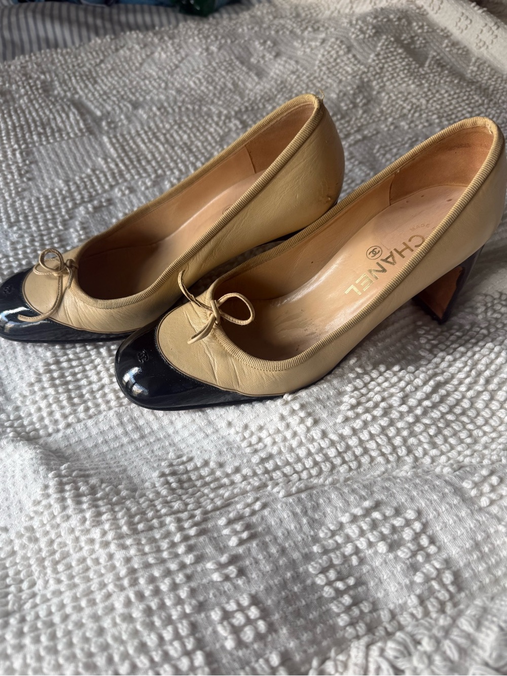 CHANEL Two-Tone Beige Leather Pumps with Black Patent Cap Toe and Bow